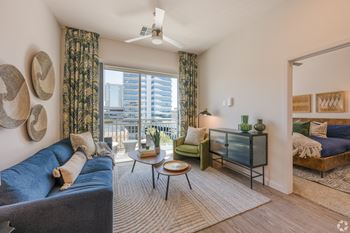 Living room with a blue couch and large window